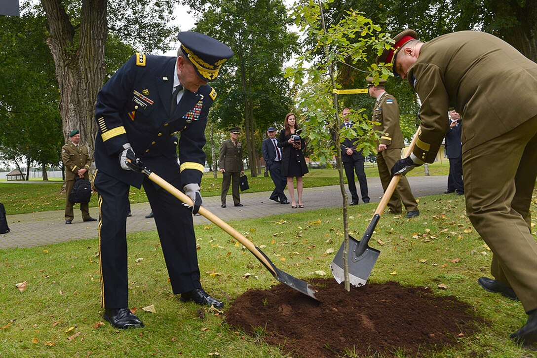 U.S. Army Gen. Martin E. Dempsey, chairman of the Joint Chiefs of Staff, and Estonian Lt. Gen. Riho Terras, commander of Estonian Defense Forces, plant an oak tree at the Estonian Defense Forces Headquarters in Tallinn, Estonia, Sept. 14, 2015. The tree symbolizes a long and growing friendship between the two nations' militaries. DoD photo by D. Myles Cullen