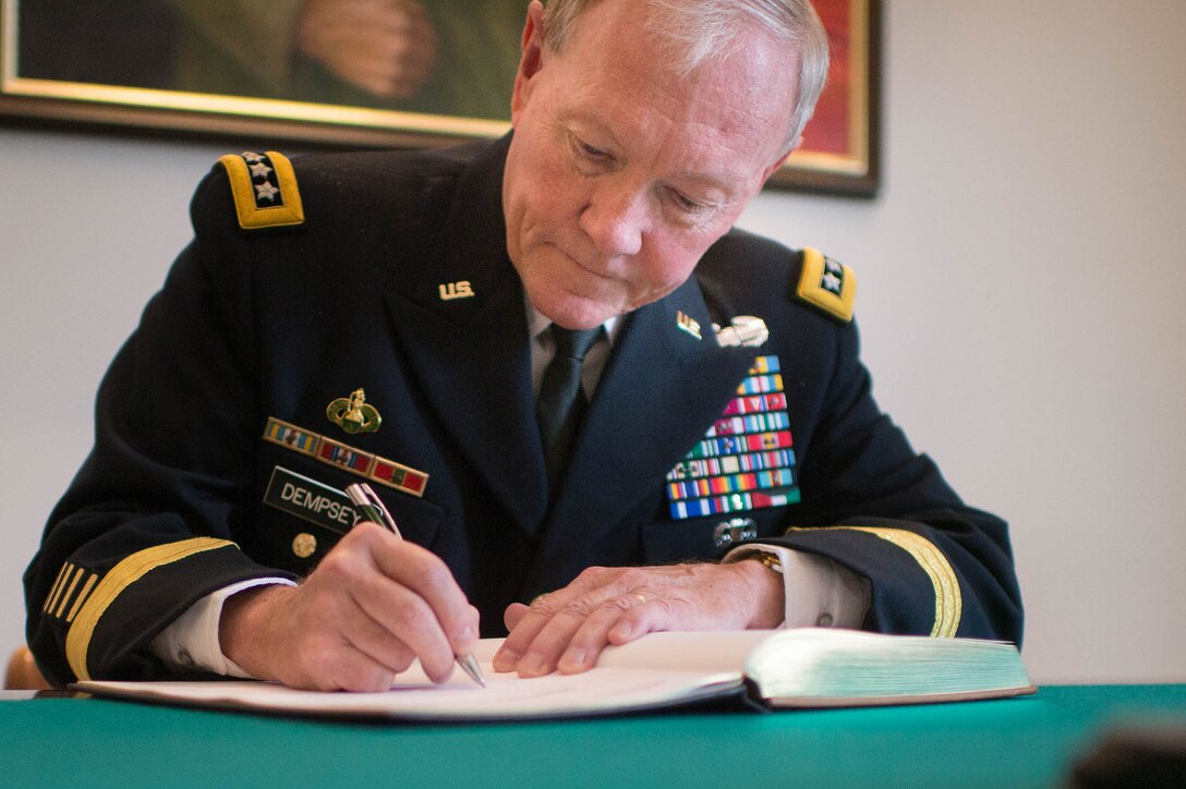 U.S. Army Gen. Martin E. Dempsey, chairman of the Joint Chiefs of Staff, signs a guest book at the Estonian Defense Forces Headquarters in Tallinn, Estonia, Sept. 14, 2015. DoD photo by D. Myles Cullen