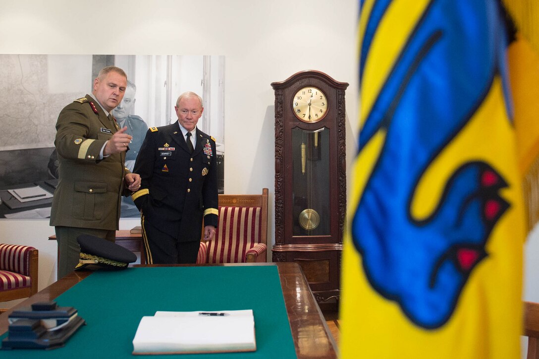 Estonian Lt. Gen. Riho Terras, commander of Estonian Defense Forces, asks U.S. Army Gen. Martin E. Dempsey, right, chairman of the Joint Chiefs of Staff, to sign a guest book at the Estonian Defense Forces Headquarters in Tallinn, Estonia, Sept. 14, 2015. DoD photo by D. Myles Cullen