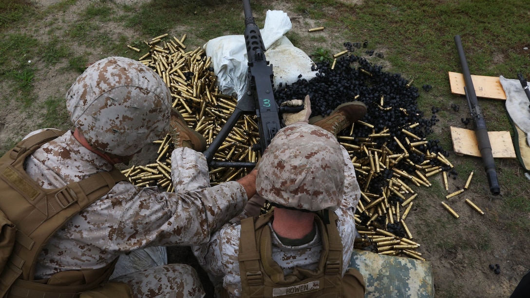 Lt. Col. Jeremy S. Winters, left, and Gunnery Sgt. Clifford Bowen reload a Browning M2 .50-caliber machine gun during a weapons familiarization range at Marine Corps Base Camp Lejeune, North Carolina, Aug. 27, 2015. More than 100 Marines from Marine Air Support Squadron 1 honed their weapons skills with the M240B machinegun, Browning M2 .50 caliber machine gun and the M1014 combat shotgun. Marines from various military job occupations received hands-on experience that allows them to improve crucial skills and become well-rounded war fighters.