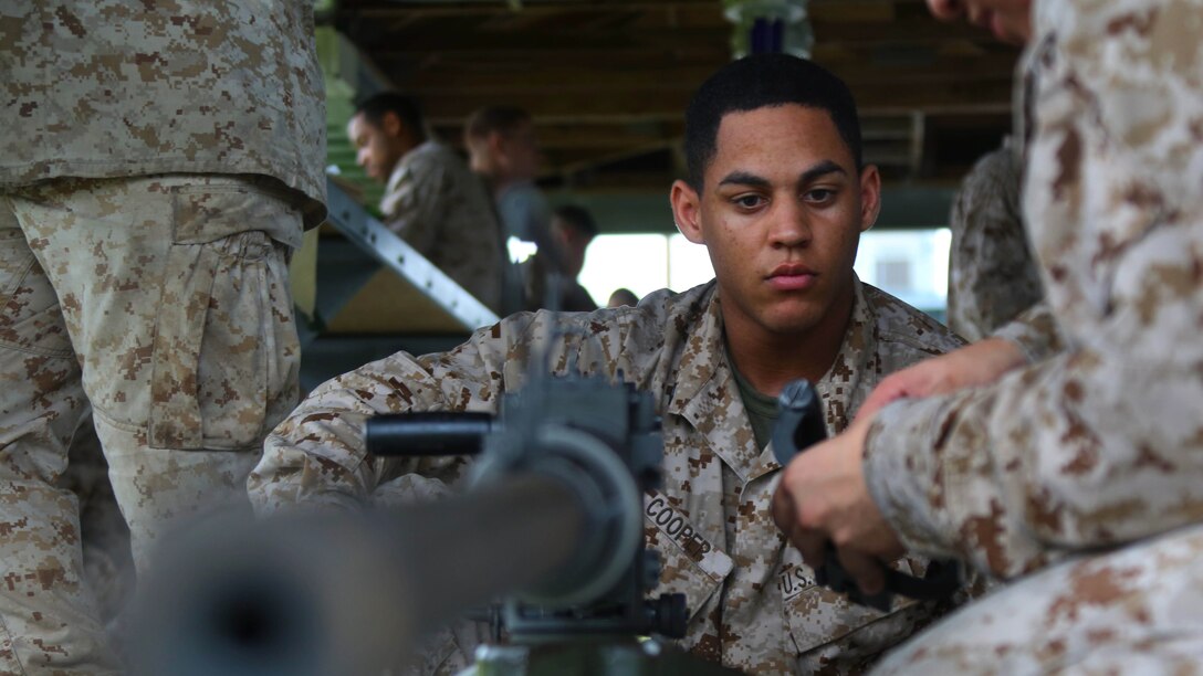 Cpl. Jevon Cooper receives a refresher class on a Browning M2 .50-caliber machine gun during a weapons familiarization range at Marine Corps Base Camp Lejeune, North Carolina, Aug. 27, 2015. More than 100 Marines from Marine Air Support Squadron 1 honed their weapons skills with the M240B machine gun, Browning M2 .50-caliber machine gun and the M1014 combat shotgun. Marines from various military job specialties received hands-on experience that allowed them to improve crucial skills and become well-rounded war fighters. Cooper is an air support operations operator with the squadron.