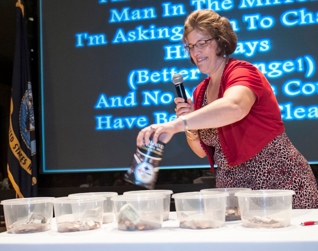 Janet Bunnell, DLA Land and Maritime CFC coordinator, gives some loose change during Land and Maritime’s CFC kickoff Sept. 10 inside the Building 20 auditorium. Attendees donated their loose change as part of the kickoff fundraiser to demonstrate that every cent counts when it comes to CFC. The campaign runs through Dec. 15.