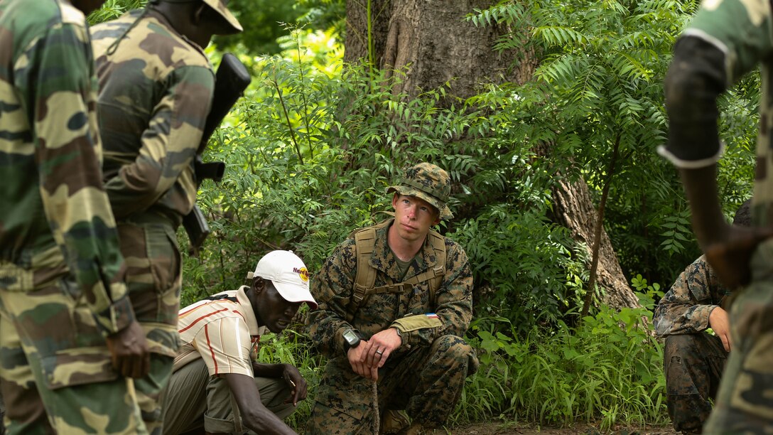 Staff Sgt. Renwand, Security Cooperation Team-4 team chief with Special-Purpose Marine Air-Ground Task Force Crisis Response-Africa, explains different techniques to cross danger areas to Compagnie Fusilier de Marin Commandos during a patrol exercise in Toubacouta, Senegal, Sept. 2, 2015. Marines, sailors and Coast Guardsmen with SCT-4 are in Senegal training with the COFUMACO on infantry tactics and small-boat operations to continue building a strong relationship between the partner nations and improve the interoperability of the Senegalese military. 