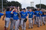 Members of the U.S. Air Force women’s softball team trade high fives while switching players out on the field during a scrimmage game Sept. 9 at Joint Base San Antonio-Randolph. The Air Force women’s softball team consists of 15 active-duty players from Air Force installations around the world, including members from Joint Base San Antonio. 