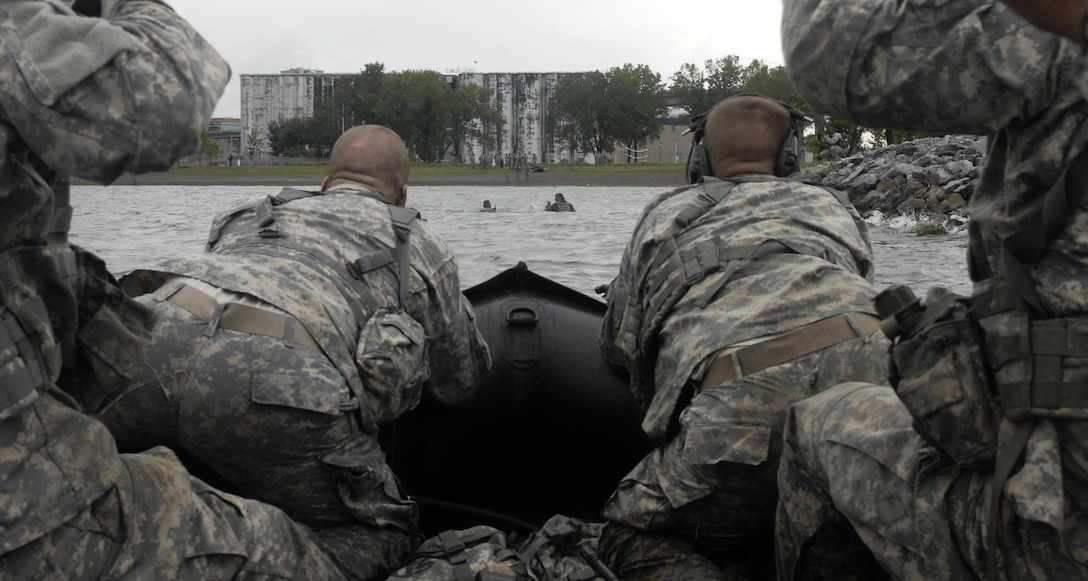 New York Army National Guard scout swimmers conduct a preliminary reconnaissance of the beach and provide security for an F470 Combat Rubber Raiding Craft during a troop training exercise in Buffalo, N.Y., Sept. 13, 2015. New York National Guard photo by Army Spc. Alexander Rector