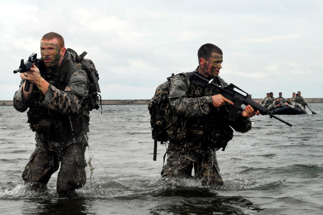 New York Army National Guard Sgt. Aaron Lawrence and Spc. Zach Bouley recon a landing site in advance of an inbound F470 Combat Rubber Raiding Craft during a troop training exercise in Buffalo, N.Y., Sept. 13, 2015. Lawrence and Bouley are infantrymen assigned to the New York Army National Guard’s Troop C, 2nd Squadron, 101st Cavalry Regiment. New York National Guard photo by Army Spc. Alexander Rector