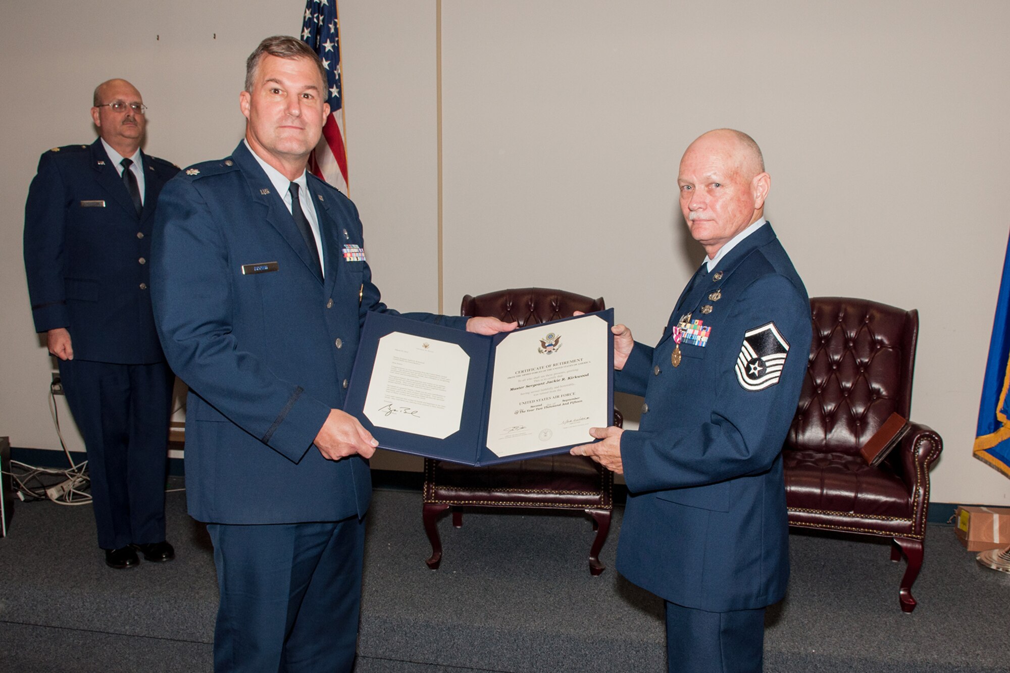 U.S. Air Force Lt. Colonel Kenneth Brown, wing chaplain of the 307th Bomb Wing, presents Master Sgt. Jackie Kirkwood with his retirement certificate on September 12, 2015 on Barksdale Air Force Base, La. Kirkwood is retiring as the Noncommissioned Officer in Charge for Chaplain Services in the 307th Bomb Wing and has over 28 years of military service. (U.S. Air Force photo by Master Sgt. Dachelle Melville/Released)
