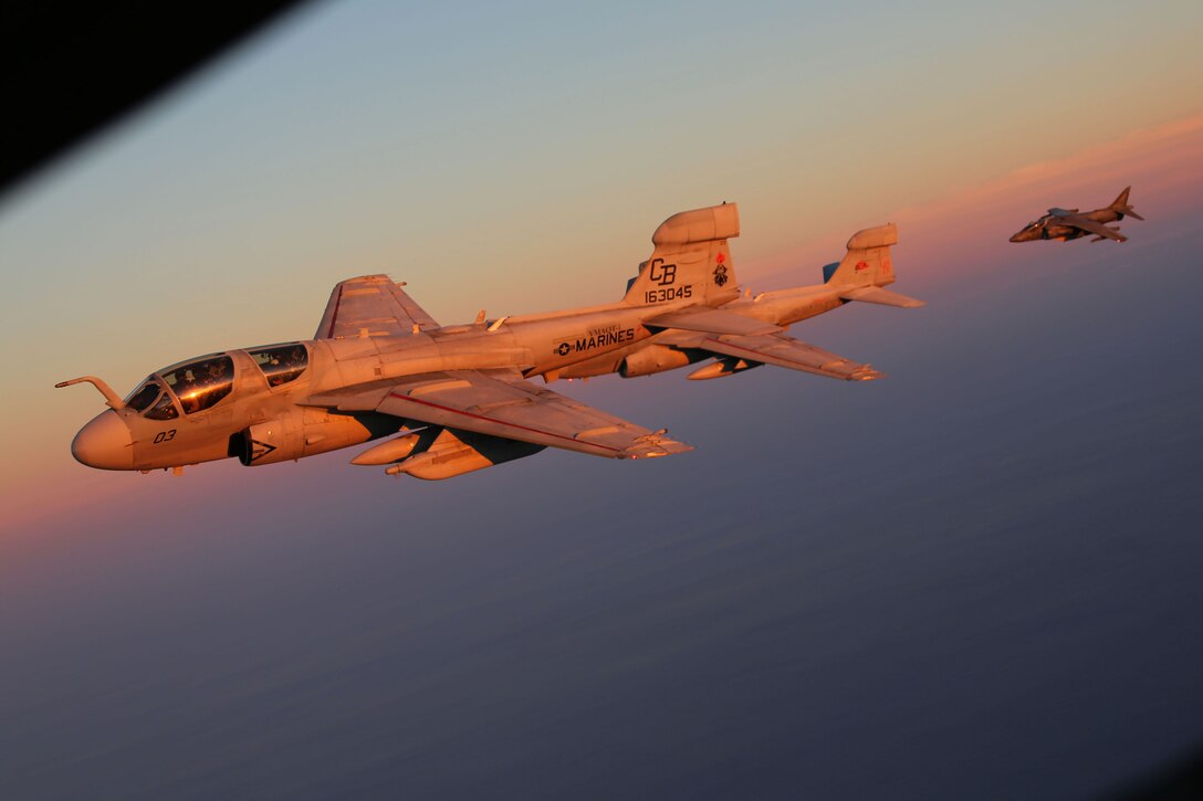 Two EA-6B Prowlers are trailed by an AV-8B Harrier while conducting aerial maneuvers during an air-to-air refuel training exercise over the Atlantic Ocean Sept. 14, 2015. Aircraft from Marine Corps Air Station Cherry Point, N.C., were supported by Marine Aerial Refueler Transport Squadron 252 off the eastern Atlantic coast during the training exercise to hone their aerial refueling skills. VMGR-252 is the force multiplier for the Marine Air-Ground Task Force as it extends the operational reach of other aviation platforms under all weather conditions, day or night during expeditionary, joint or combined operations. (U.S. Marine Corps photo by Cpl. N.W. Huertas/Released)