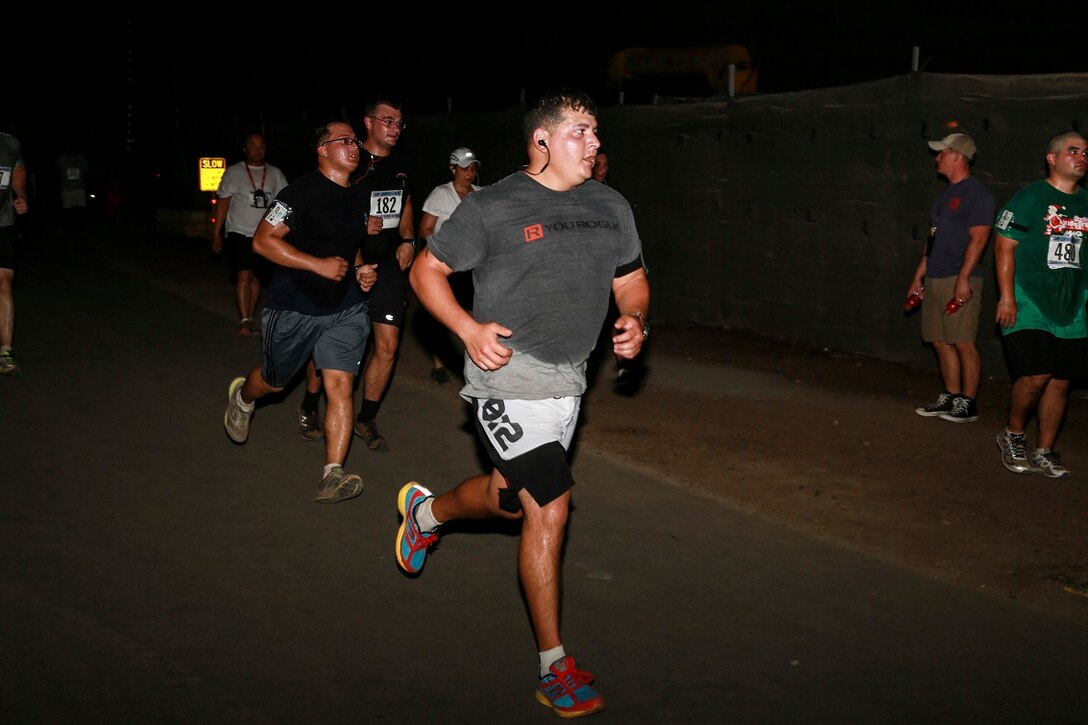 CAMP LEMONNIER, Djibouti (Sept. 6, 2015) U.S. Marines with the 15th Marine Expeditionary Unit, alongside other service members, run a 5K race aboard Camp Lemonnier. The Marines used the race to build camaraderie, acclimatize to Djibouti’s temperatures, and stay fit. Elements of the 15th MEU are preparing to conduct bilateral training with the 5th Overseas Combined Arms Regiment (RIAOM) in Djibouti in order to improve interoperability between the MEU and the French military. (U.S. Marine Corps photo by Sgt. Steve H. Lopez/Released)