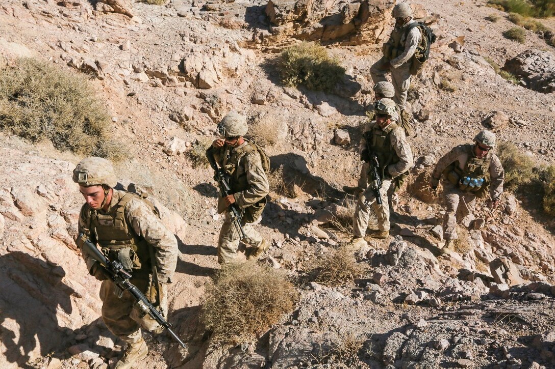 SOUTHWEST ASIA (Sept. 2, 2015) U.S Marines with India Company, Battalion Landing Team 3rd Battalion, 1st Marine Regiment, 15th Marine Expeditionary Unit, traverse rough terrain on approach to their objective during a bi-lateral training exercise. The 15th MEU, embarked aboard the ships of the ESX ARG, is a forward-deployed, flexible sea-based MAGTF capable of engaging with regional partners and maintaining regional security. (U.S. Marine Corps photo by Sgt. Jamean Berry/Released)