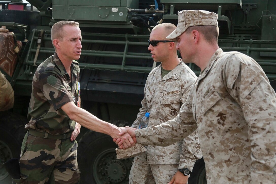 CAMP LEMONNIER, Djibouti (Sept. 9, 2015) U.S. Marine Sgt. Samuel Krebs, right, shakes hands with a French officer from the French 5th Overseas Combined Arms Regiment (RIAOM) during a static display. Krebs is a vehicle commander with Weapons Company, Battalion Landing Team 3rd Battalion, 1st Marine Regiment, 15th Marine Expeditionary Unit. Elements of the 15th MEU are preparing to conduct bilateral training with the 5th RIAOM in Djibouti in order to improve interoperability between the MEU and the French military. (U.S. Marine Corps photo by Sgt. Steve H. Lopez/Released)