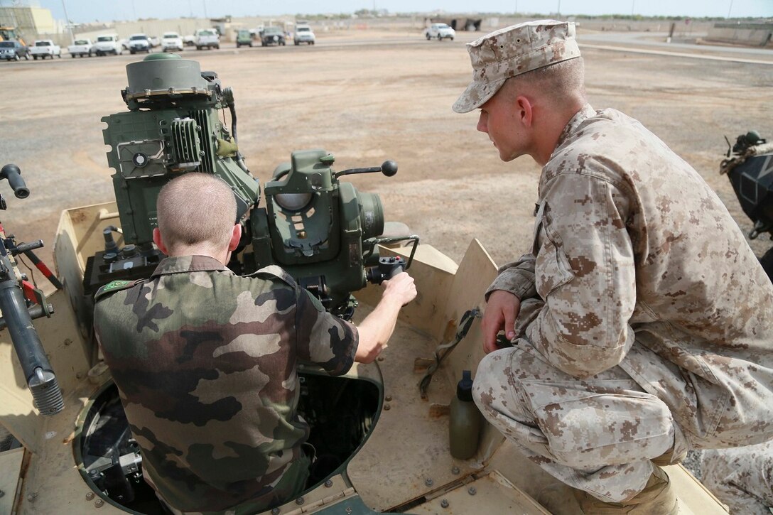CAMP LEMONNIER, Djibouti (Sept. 9, 2015) U.S. Marine Lance Cpl. Jedediah Vance, right, explains the functions of an M41 Saber System to a French officer from the French 5th Overseas Combined Arms Regiment (RIAOM). Vance is a gunner with Weapons Company, Battalion Landing Team 3rd Battalion, 1st Marine Regiment, 15th Marine Expeditionary Unit. Elements of the 15th MEU are preparing to conduct bilateral training with the 5th RIAOM in Djibouti in order to improve interoperability between the MEU and the French military. (U.S. Marine Corps photo by Sgt. Steve H. Lopez/Released)