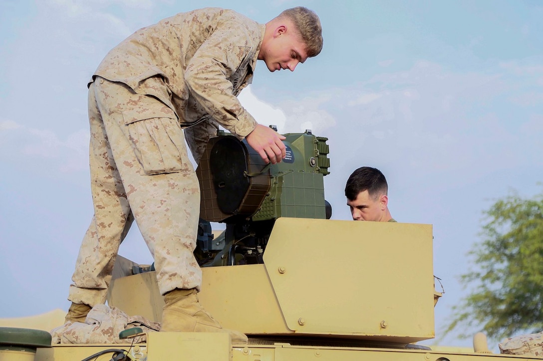 CAMP LEMONNIER, Djibouti (Sept. 9, 2015) U.S. Marine Lance Cpl. Jedediah Vance, left, mounts an M41 Saber System onto a Humvee before a weapons and vehicle display with French forces. Vance is a gunner with Weapons Company, Battalion Landing Team 3rd Battalion, 1st Marine Regiment, 15th Marine Expeditionary Unit. Elements of the 15th MEU are preparing to conduct bilateral training with the 5th Overseas Combined Arms Regiment (RIAOM) in Djibouti in order to improve interoperability between the MEU and the French military. (U.S. Marine Corps photo by Sgt. Steve H. Lopez/Released)