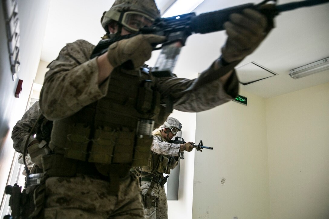 NAVAL SUPPORT ACTIVITY BAHRAIN (Sept. 9, 2015) U.S. Marines with the Fleet Anti-terrorism Security Team practice close-quarter battle tactics aboard Naval Support Activity Bahrain. These Marines were sharing techniques, tactics, and procedures with the 15th Marine Expeditionary Unit’s Force Reconnaissance Detachment. The 15th MEU is embarked with the Essex Amphibious Ready Group and deployed to maintain regional security in the U.S. 5th Fleet area of operations. (U.S. Marine Corps photo by Cpl. Anna Albrecht/Released)