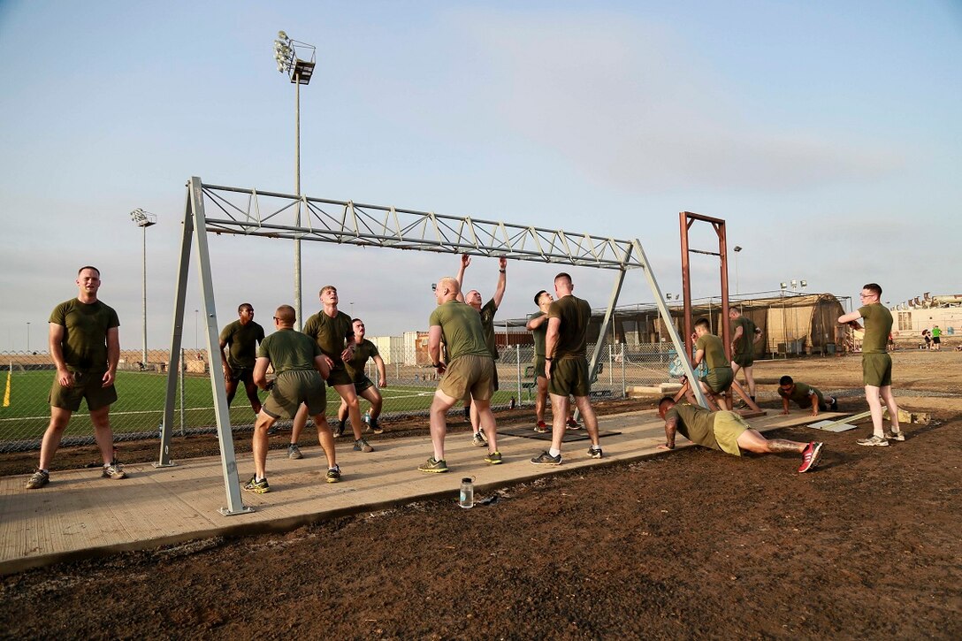 CAMP LEMONNIER, Djibouti (Sept. 11, 2015) U.S. Marines with Weapons Company, Battalion Landing Team 3rd Battalion, 1st Marine Regiment, 15th Marine Expeditionary Unit, do various exercises such as pulls ups, air squats, and push-ups during unit physical training. The Marines use unit PT to acclimatize to Djibouti’s temperatures, and stay fit. Elements of the 15th MEU are preparing to conduct bilateral training with the 5th Overseas Combined Arms Regiment (RIAOM) in Djibouti in order to improve interoperability between the MEU and the French military. (U.S. Marine Corps photo by Sgt. Steve H. Lopez/Released)