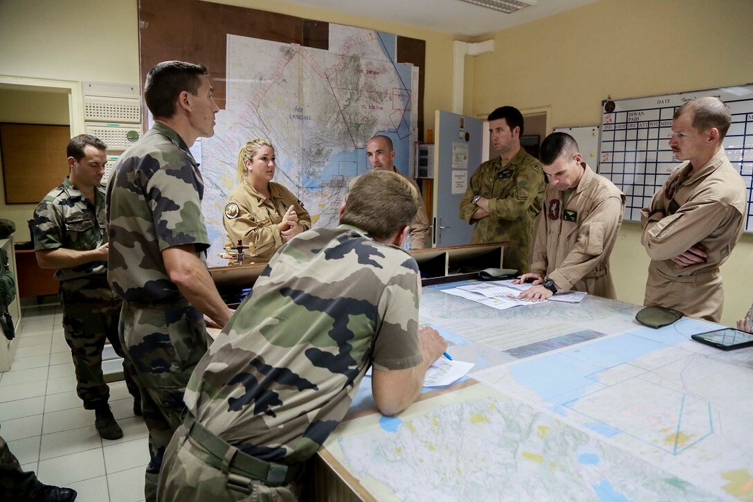 BASE AERIENNE 188, Djibouti (Sept. 9, 2015) U.S. Marines with Marine Medium Tiltrotor Squadron 161 (Reinforced), 15th Marine Expeditionary Unit, and French officers with the French 5th Overseas Combined Arms Regiment (RIAOM) plan for future training and discuss capabilities. Elements of the 15th MEU are preparing to conduct bilateral training with the 5th RIAOM in Djibouti in order to improve interoperability between the MEU and the French military. (U.S. Marine Corps photo by Sgt. Steve H. Lopez/Released)
