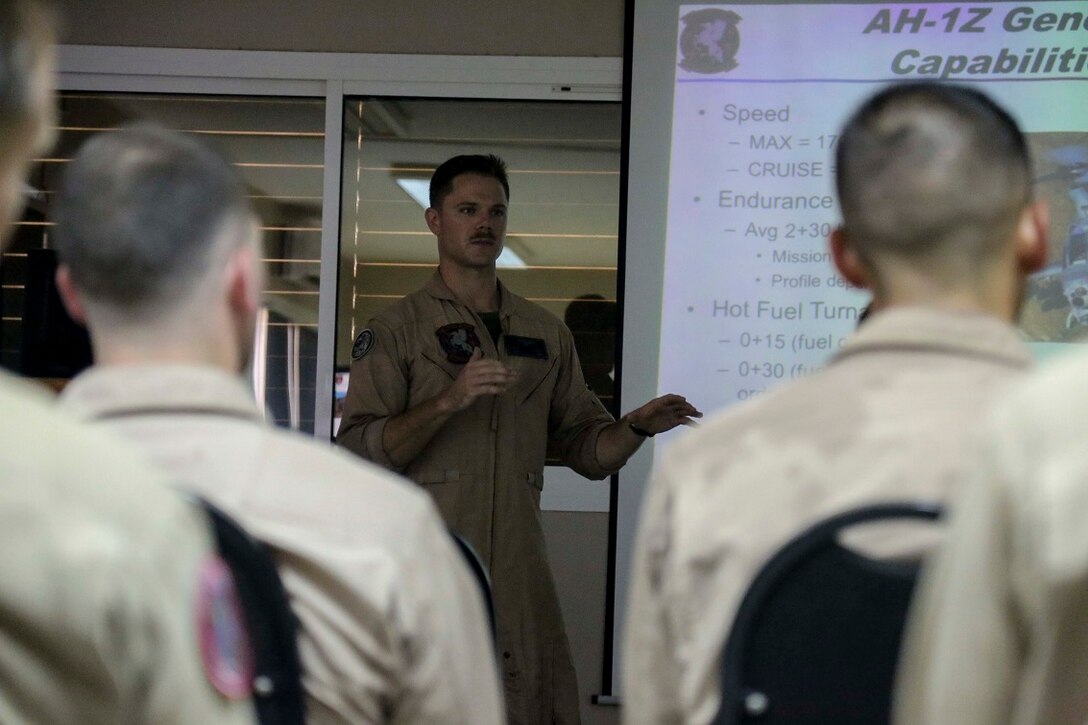 BASE AERIENNE 188, Djibouti (Sept. 9, 2015) U.S. Marine Capt. Matt Davis, middle, briefs French officers with the French 5th Overseas Combined Arms Regiment (RIAOM) on the capabilities of U.S. Marine Corps aircraft and weapons systems. Davis is a weapons and tactics instructor with Marine Medium Tiltrotor Squadron 161 (Reinforced), 15th Marine Expeditionary Unit. Elements of the 15th MEU are preparing to conduct bilateral training with the 5th RIAOM in Djibouti in order to improve interoperability between the MEU and the French military. (U.S. Marine Corps photo by Sgt. Steve H. Lopez/Released)