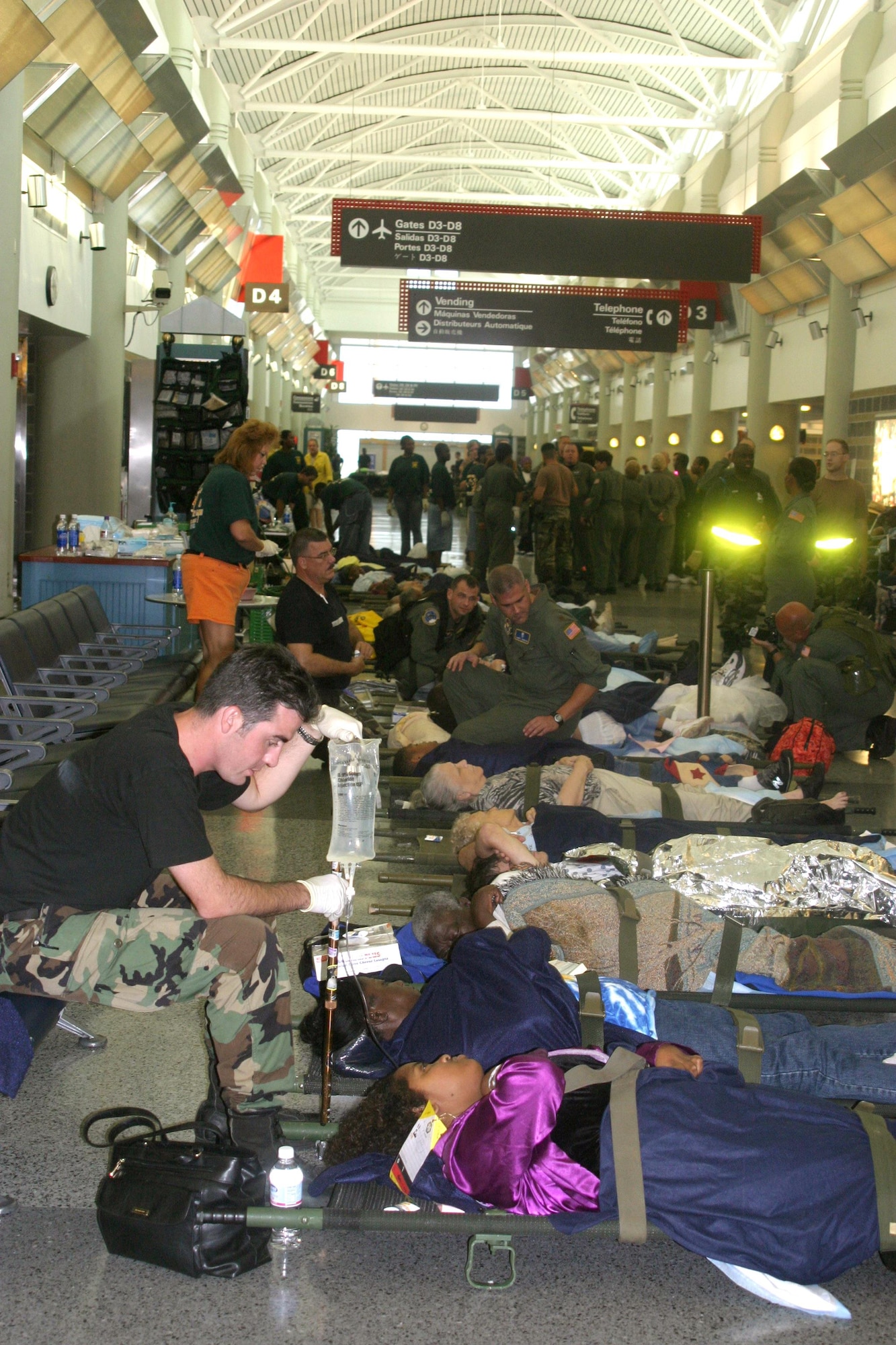 Air Force medical personnel attend to patients awaiting airlift from New Orleans.  C-130 crews from Little Rock Air Force Base's 50th AIrlift Squadron teamed with the 452nd to relocate sick and injured patients devastated after Hurricane Katrina. (Courtesy photo by 1st Lt. Jon Quinlan)