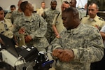 Army Sgt. Nathan Corley, an electronics mechanic, demonstrates equipment calibration during a South Carolina National Guard hosted visit for students from the Colombian War College at McEntire Joint National Guard Base in Eastover, S.C., Sept. 10, 2015 as part of the U.S. National Guard's State Partnership Program. These students are the future senior leaders of the Colombian army and the cultural and military exchange facilitated by this engagement is expected to further strengthen and develop this multinational initiative. (Air National Guard Photo by Airman Megan R. Floyd)