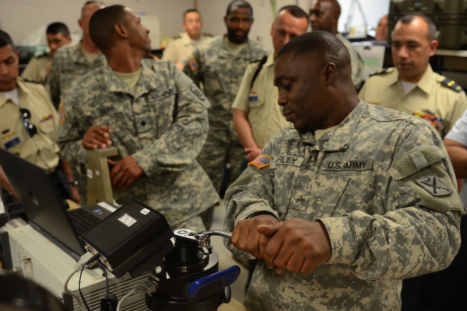 Army Sgt. Nathan Corley, an electronics mechanic, demonstrates equipment calibration during a South Carolina National Guard hosted visit for students from the Colombian War College at McEntire Joint National Guard Base in Eastover, S.C., Sept. 10, 2015 as part of the U.S. National Guard's State Partnership Program. These students are the future senior leaders of the Colombian army and the cultural and military exchange facilitated by this engagement is expected to further strengthen and develop this multinational initiative. (Air National Guard Photo by Airman Megan R. Floyd)