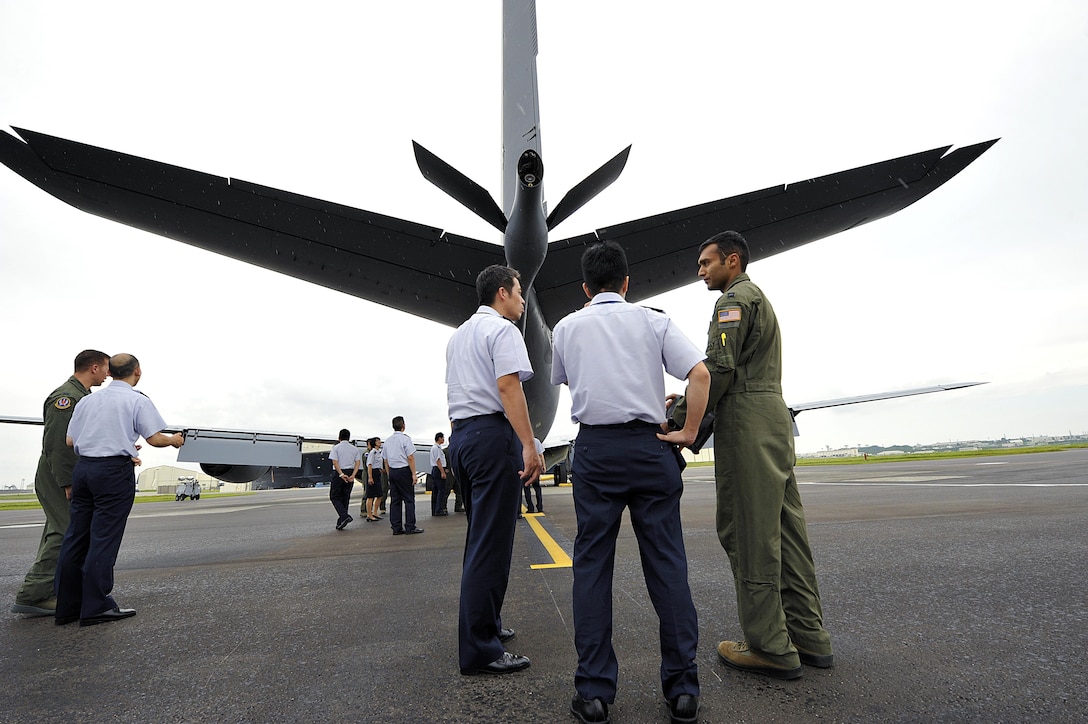 U.S. Air Force Capt. Karan Bansal explains to Japan Air Self-Defense Force officers how to operate a KC-135 Stratotanker boom during a tour of Kadena Air Base near Okinawa, Japan, Sept. 16, 2015. U.S. Air Force photo by Naoto Anazawa