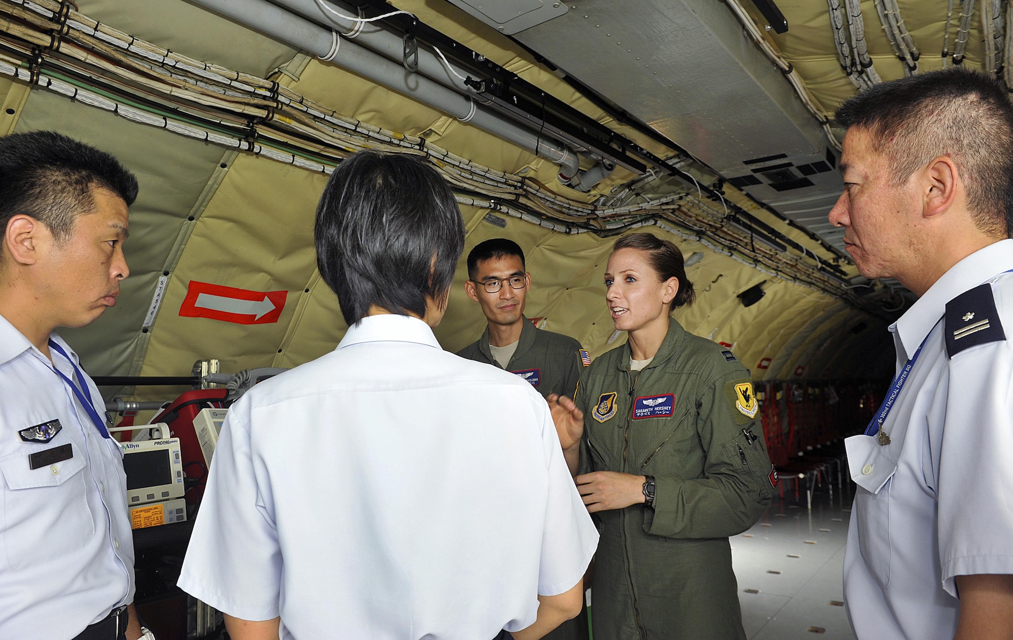 U.S. Air Force Capt. Sarabeth Hershey, 18th Aeromedical Evacuation Squadron flight nurse, answers question from Japan Air Self-Defense Force officers during a tour Sept. 16, 2015 at Kadena Air Base, Japan. The tour provided JASDF officers an opportunity to see first-hand examples of day-to-day operations and ask questions to technical experts about the various aspects of Kadena's aircraft operations. (U.S. Air Force photo by Naoto Anazawa/Released)