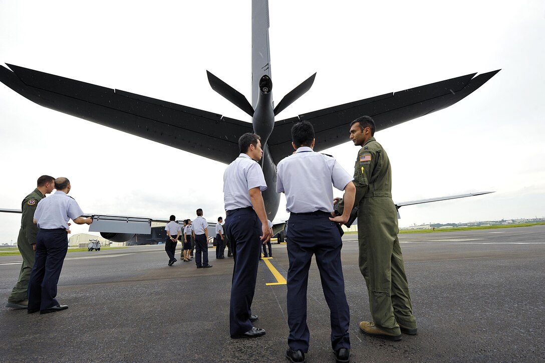U.S. Air Force Capt. Karan Bansal, 909th Air Refueling Squadron KC-135 Stratotanker pilot, explains to Japan Air Self-Defense Force officers how to operate a KC-135 Stratotanker boom during a tour Sept. 16, 2015 at Kadena Air Base, Japan. The 18th Operations Group provided an opportunity for the JADSF officers to learn Kadena's aircraft operations, mission, capabilities, and to gain a better understanding of American processes and procedures. (U.S. Air Force photo by Naoto Anazawa/Released)