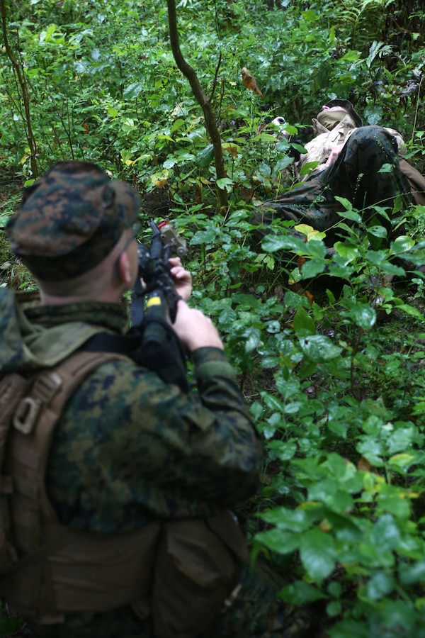 EVANGOLA STATE PARK, N.Y. - A Marine with 1st Battalion, 25th Marine Regiment, 4th Marine Division, Marine Forces Reserve, prepares to inspect a simulated downed enemy combatant during exercise Lake Effect at Evangola State Park, New York, Sept. 12, 2015. Each platoon in Charlie Co. set up their own patrol bases and routes which occasionally lead to confrontation with the other platoons, adding an element of realism to the training. (U.S. Marine Corps Photo By Cpl. J. Gage Karwick/Released)