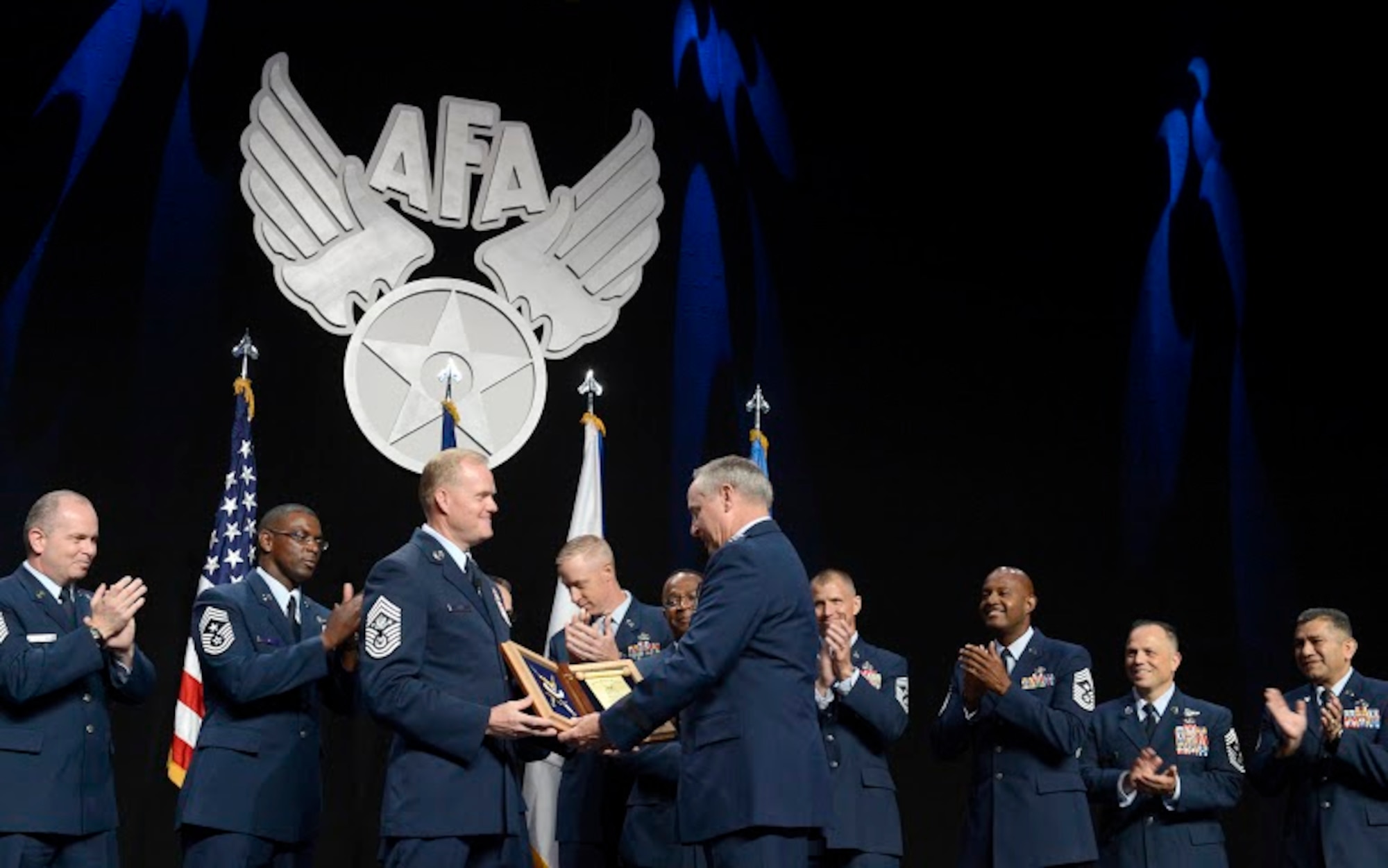 Chief Master Sgt. of the Air Force James A. Cody thanks Air Force Chief of Staff Gen. Mark A. Welsh III for his exceptional service by presenting him with an invitation to an Order of the Sword ceremony following Cody's Enlisted Force Update at the Air Force Association's Air and Space Conference and Technology Exposition Sept. 16, 2015, in Washington, D.C. (U.S. Air Force photo/Scott M. Ash)  