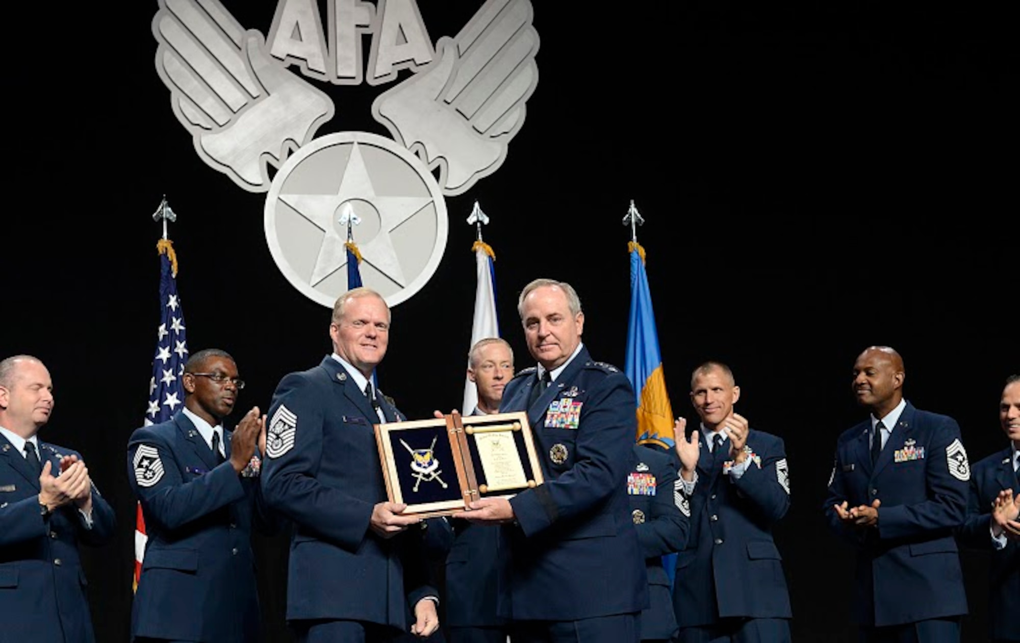 Chief Master Sgt. of the Air Force James A. Cody thanks Air Force Chief of Staff Gen. Mark A. Welsh III for his exceptional service by presenting him with an invitation to an Order of the Sword ceremony following Cody's "Enlisted Force Update" at Air Force Association's Air and Space Conference and Technology Exposition Sept. 16, 2015, in Washington, D.C.  (U.S. Air Force photo/Scott M. Ash)  