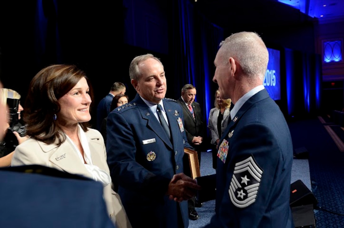 Air Force Chief of Staff Gen. Mark A. Welsh III (center) and his wife, Betty, are congratulated by an Air Force command chief master sergeant after Chief Master Sgt. of the Air Force James A. Cody presented Welsh with an invitation to an Order of the Sword ceremony following Cody's Enlisted Force Update at the Air Force Association's Air and Space Conference and Technology Exposition Sept. 16, 2015, in Washington, D.C. (U.S. Air Force photo/Scott M. Ash)