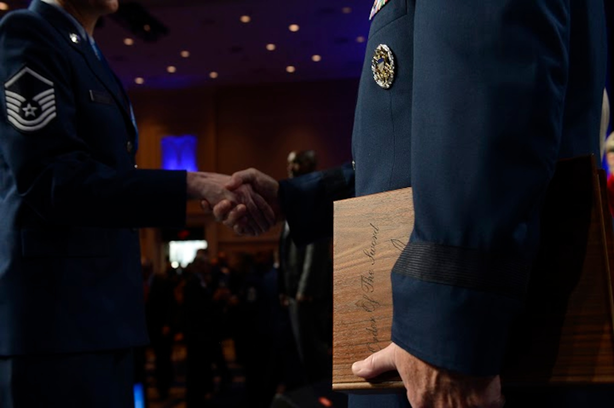 An Air Force Master Sergeant congratulates Air Force Chief of Staff Gen. Mark A. Welsh III after Chief Master Sgt. of the Air Force James A. Cody presented Welsh with an invitation to an Order of the Sword ceremony following Cody's Enlisted Force Update at the Air Force Association's Air and Space Conference and Technology Exposition Sept. 16, 2015, in Washington, D.C  (U.S. Air Force photo/Scott M. Ash)