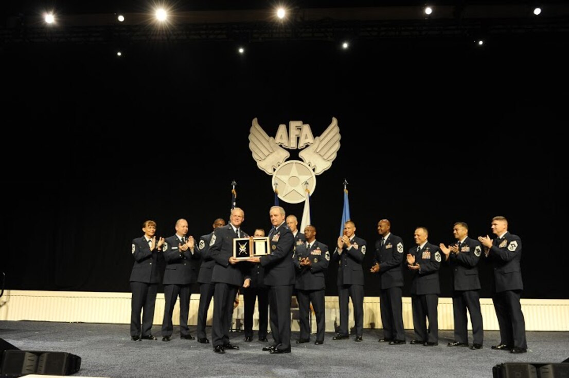 Chief Master Sgt. of the Air Force James A. Cody thanks Air Force Chief of Staff Gen. Mark A. Welsh III for his exceptional service by presenting him with an invitation to an Order of the Sword ceremony, following Cody's Enlisted Force Update at the Air Force Association's Air and Space Conference and Technology Exposition Sept. 16, 2015, in Washington, D.C.(U.S. Air Force photo/Staff Sgt. Whitney Stanfield)