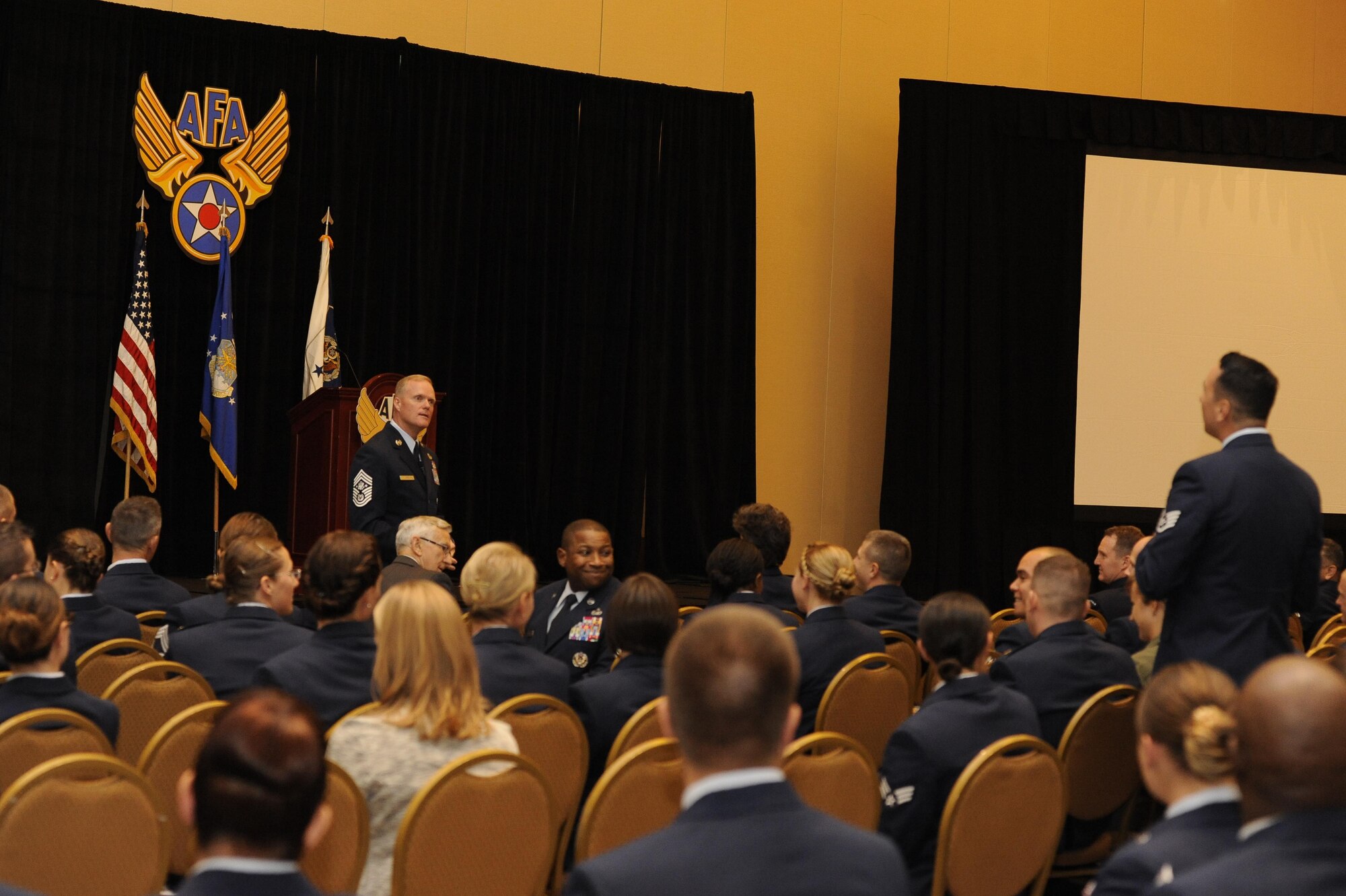 Staff Sgt Jireh Aki, a installation antiterrorism officer at Joint Base Andrews, Md., asks Chief Master Sgt. of the Air Force James A. Cody a question during the Air Force Association Air and Space Conference and Technology Exposition in Washington, D.C., Sept. 16, 2015. Cody said each Air Force generation gets better with technology and education, but if they do not, then the leaders have failed them. (Air Force photo/Staff Sgt. Whitney Stanfield)