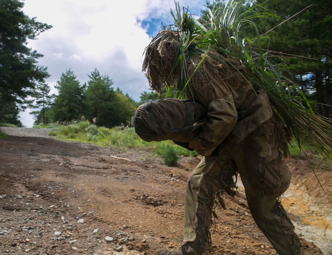 Navy Petty Officer 3rd Class Deven Lewis runs across a clearing while participating in stalking drills during Forest Light 16-1 at Camp Imazu, Takashima, Japan, Sept. 10, 2015. The Marines sat up on a high embankment, trying to catch Lewis stalking the target with binoculars. Forest Light is a semiannual, bilateral exercise consisting of a command post exercise and multiple field training events, conducted by elements of III Marine Expeditionary Force and the JGSDF. Lewis from Idaho Falls, Idaho, is a hospital corpsman with 1st Battalion, 2nd Marine Regiment currently assigned to 4th Marine Regiment, 3rd Marine Division, III Marine Expeditionary Force. 