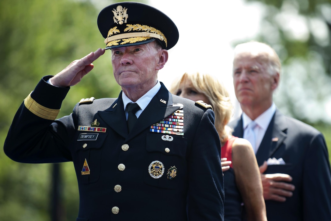 Army Gen. Martin E. Dempsey, chairman of the Joint Chiefs of Staff, salutes during the playing of the national anthem as Vice President Joe Biden and his wife, Dr. Jill Biden, look on during a ceremony commemorating the 50th anniversary of the Vietnam War at the Vietnam Veterans Memorial wall in Washington, D.C., May 28, 2012. DoD photo by U.S. Navy Petty Officer 1st Class Chad J. McNeeley