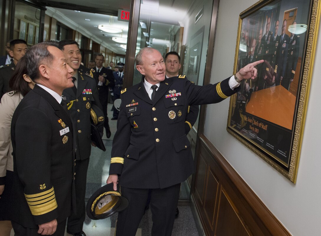 U.S. Army Gen. Martin E. Dempsey points out a photo of the U.S. military's branch chiefs to his South Korean counterpart, South Korean Navy Adm. Choi Yoon-hee, at the Pentagon, March 11, 2014. DoD photo by U.S. Army Staff Sgt. Sean K. Harp