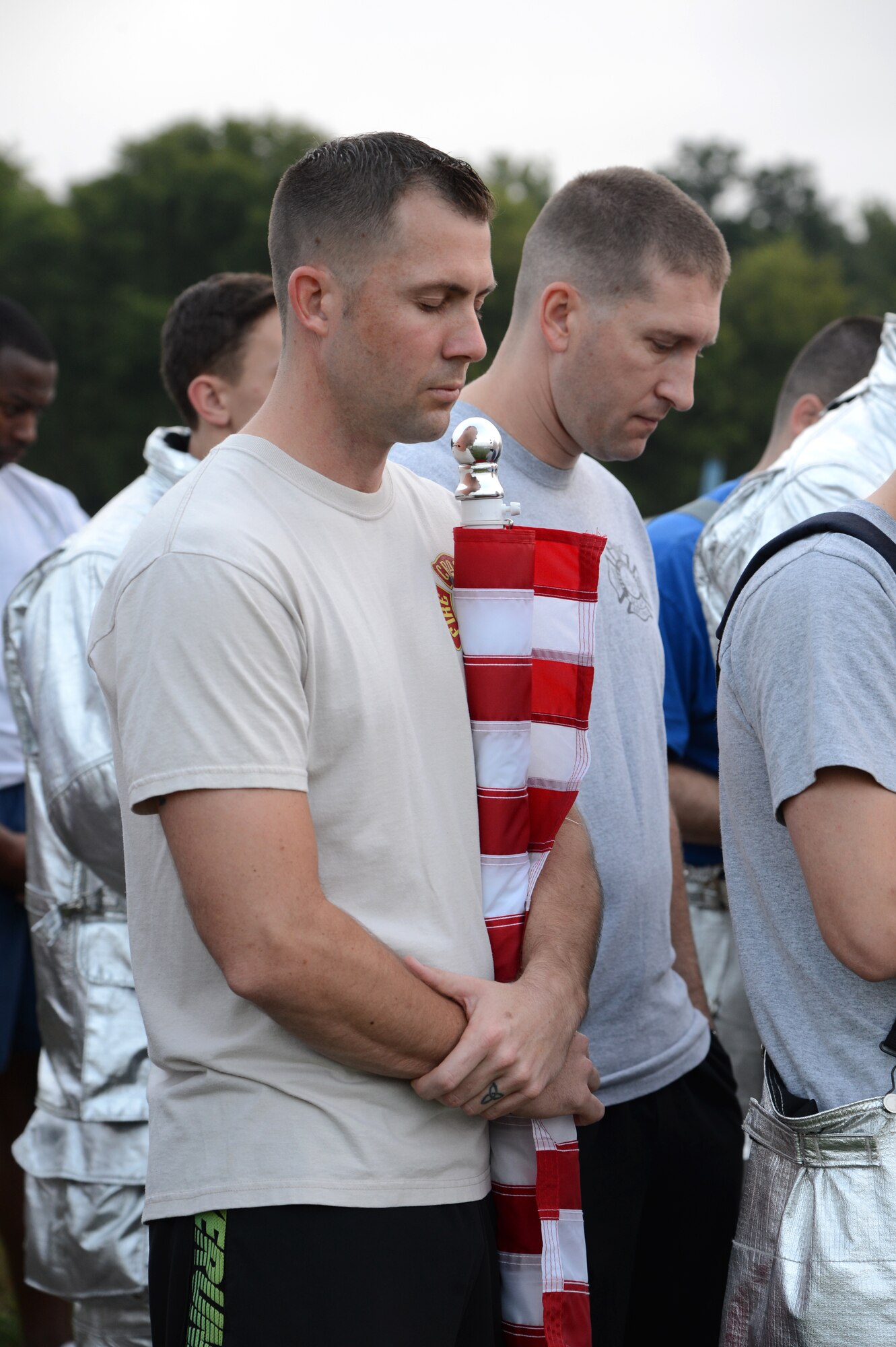Members of Team Barksdale participate in a moment of silence during the Sept. 11, remembrance 5K Run on Barksdale Air Force Base La., Sept. 11, 2015. Every month the Senior Airman Bryan Bell Fitness Center hosts a base 5k with a different theme to promote wellness and fitness. (U.S. Air Force photo/Senior Airman Joseph A. Pagán Jr.) 
