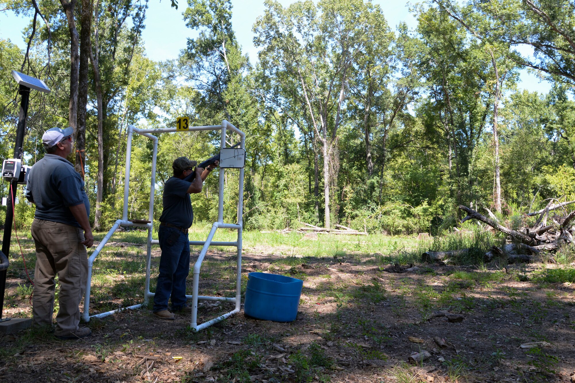 Otis Kimmons, 2nd Force Support Squadron Outdoor Recreation aid, left, signals Paul Williamson, 2nd FSS Outdoor Recreation director, to launch a target at the Red Chute Shotgun Sports Club on Barksdale Air Force Base, La., Sept. 14, 2015. The new sporting clays range is 1.2 miles long and features 14 battery-operated, solar-charged stations and programmable delayed-release card reader systems. (U.S. Air Force photo/Senior Airman Jannelle Dickey)