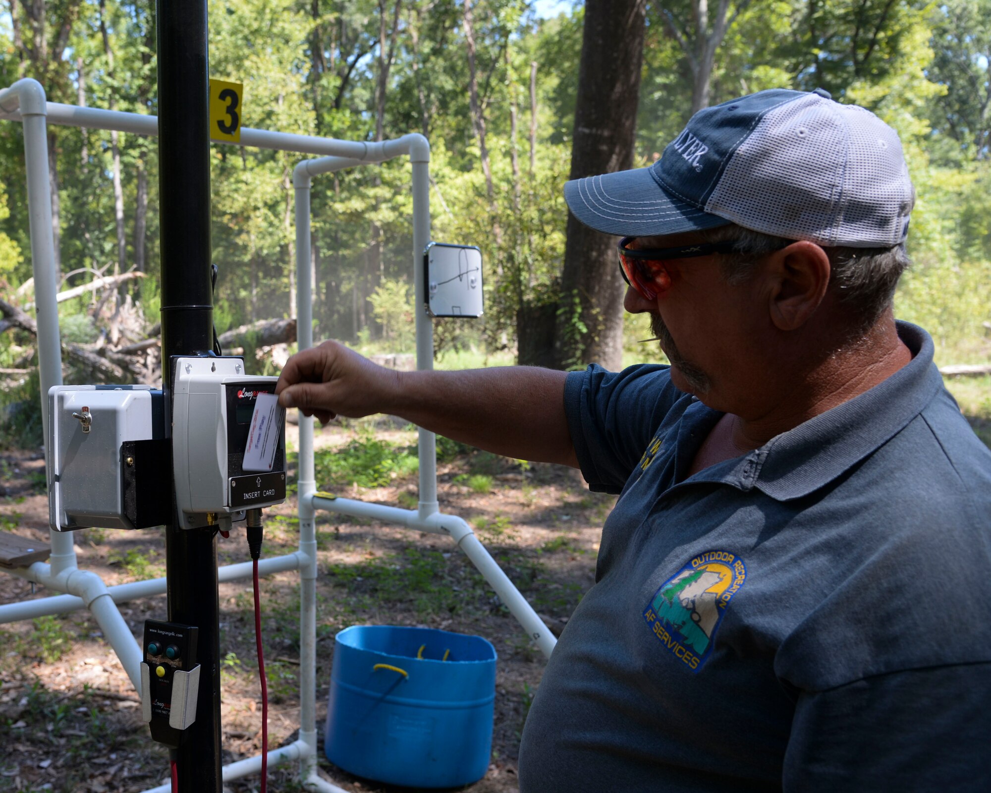Paul Williamson, 2nd Force Support Squadron Outdoor Recreation director, uses the card reading system at the Red Chute Shotgun Sports Club on Barksdale Air Force Base, La., Sept. 14, 2015. The new programmable delayed-release card reader system electronically counts targets launch and allows individuals to release their own targets. (U.S. Air Force photo/Senior Airman Jannelle Dickey)