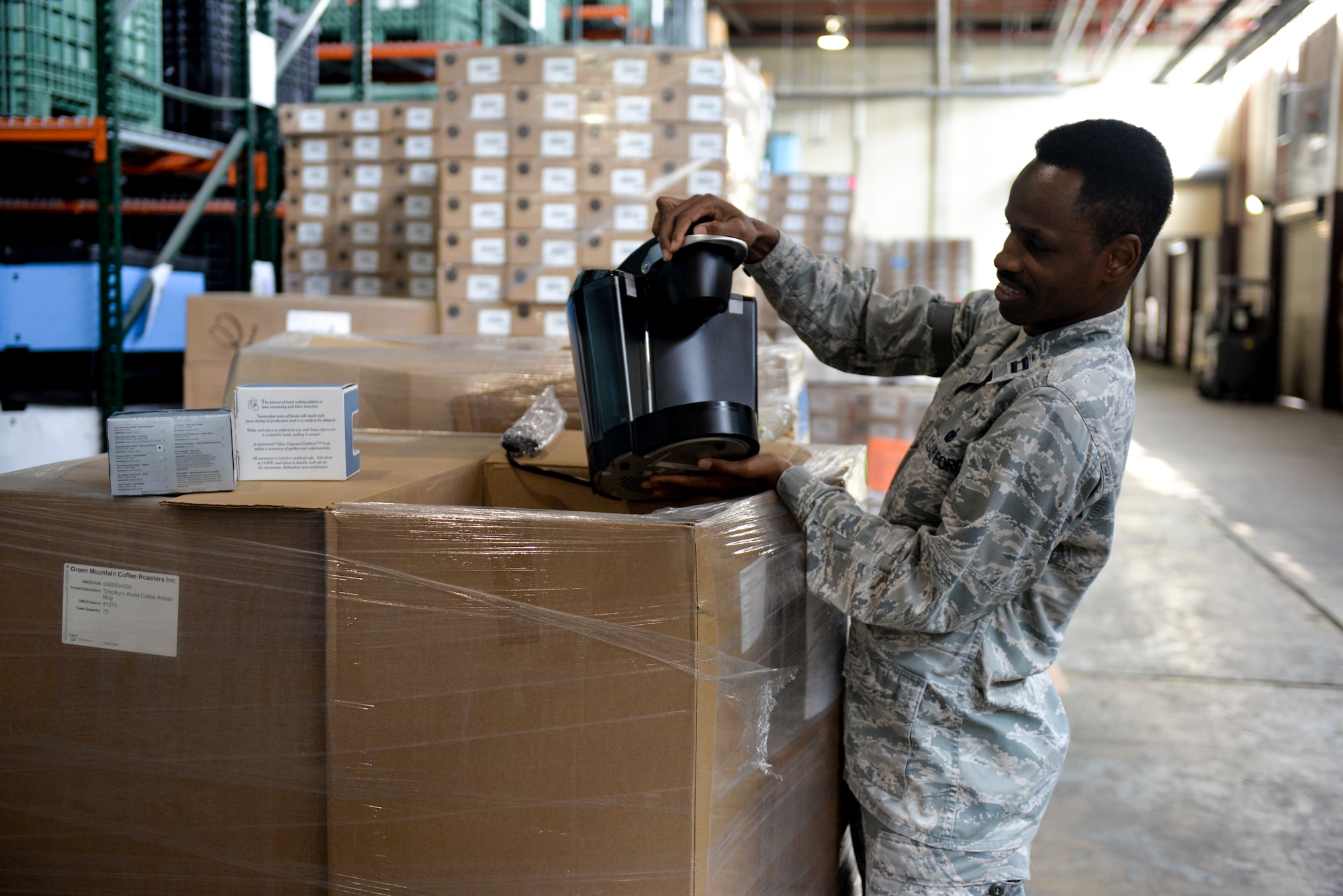 Capt. Kennie Neal, 2nd Bomb Wing chaplain, unpacks a pallet of donated coffee makers at Barksdale Air Force Base, La., Aug. 24, 2015. The donation included 25 pallets of coffee and 40 coffee machines with an estimated cost of $8,100. (U.S. Air Force Photo/Airman 1st Class Mozer O. Da Cunha)