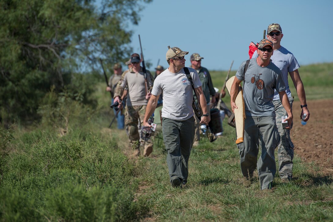 Sheppard Air Force Base, Texas, Airmen walk out to a hunting area during the Clay County Dove Salute in Henrietta, Texas, Sept. 12, 2015. Airmen were invited to the ranch to participate in dove hunt and a Texas-style steak dinner. (U.S. Air Force photo by Senior Airman Kyle Gese/Released)
