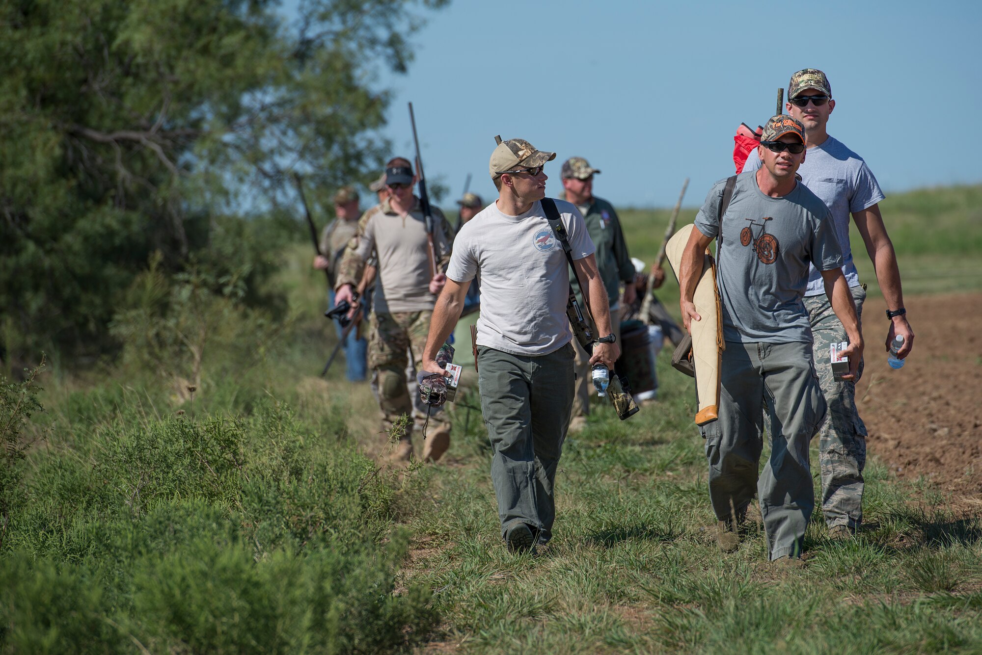 Sheppard Air Force Base, Texas, Airmen walk out to a hunting area during the Clay County Dove Salute in Henrietta, Texas, Sept. 12, 2015. Airmen were invited to the ranch to participate in dove hunt and a Texas-style steak dinner. (U.S. Air Force photo by Senior Airman Kyle Gese/Released)
