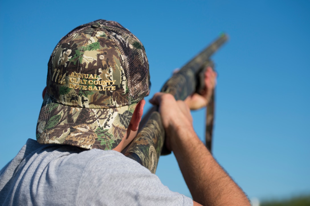 First Lt. Jordan Gegner, 80th Training Wing student pilot, fires his shotgun at a dove passing during the 11th Annual Clay County Dove Salute, Sept. 12, 2015. Each year, the several Clay County ranches host the Dove Salute as a thank you to service members stationed at Sheppard Air Force Base, Texas, for their service. Airmen were invited to the Birdwell and Clark Ranch to participate in dove hunt and a Texas-style steak dinner. (U.S. Air Force photo by Senior Airman Kyle Gese/Released)