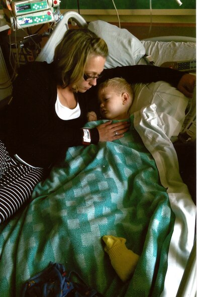 Jaycee Boyer, wife of Tech. Sgt. Tim Boyer, 56th Fighter Wing Public Affairs media operations NCO in charge, comforts Paul, 2, after his surgery on his brain due to a tumor in Ariz. (Courtesy photo)