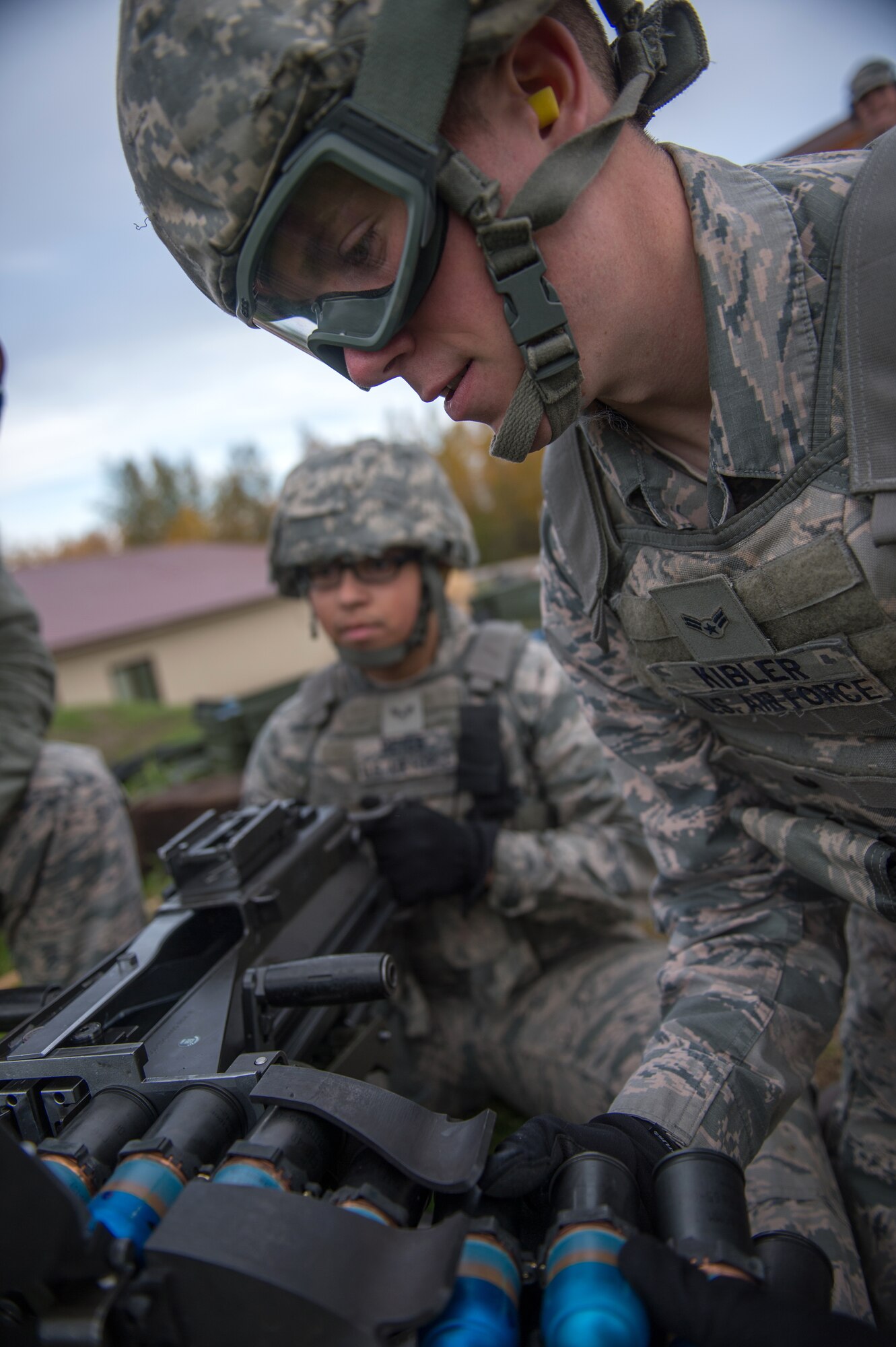 Airman 1st Class Nathaniel Kibler, a 354th Security Forces Squadron response force member, loads a belt of rounds into a Mark 19 grenade launcher Sept. 9, 2015, at Eielson Air Force Base, Alaska. The weapon, which was first developed in the Vietnam War, takes two Airmen to operate, one to load and one to fire. (U.S. Air Force photo by Staff Sgt. Shawn Nickel/Released)