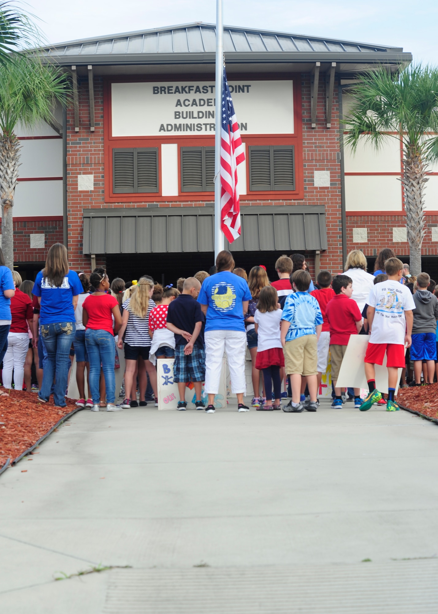 Students from Breakfast Point Academy gather at the flag post Sept. 11 for a flag raising, memorial ceremony and to listen to speakers from the Panama City Fire and Police Departments. The school had more than 1,200 students and teachers that attended of this event.  (U.S. Air Force photo by Airman 1st Class Solomon Cook/Released)