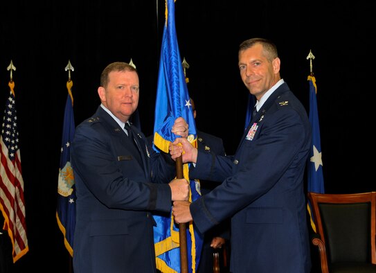 Col. David. P. Garfield, right, accepts the 482nd Fighter Wing guidon and command of the unit from Maj. Gen. Richard W. Scobee, the 10th Air Force commander, during a change-of-command ceremony in Building 471, at Homestead Air Reserve Base, Florida, Sept. 13. (U.S. Air Force photo by Senior Airman Frank Casciotta)  