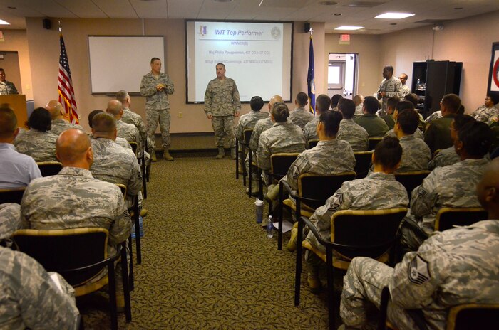 Col. Johnny Lamontagne, 437th Airlift Wing commander and Command Chief Master Sergeant Kristopher Berg of the 437 AW, take questions during an all call from the Wing Inspection Team (WIT) at Joint Base Charleston - Air Base, S.C., Sept. 14, 2015. During these all calls, the Inspector General team updates WIT members on current processes around the installation and leadership recognizes top performers. (U.S. Air Force photo by James Bowman/released)