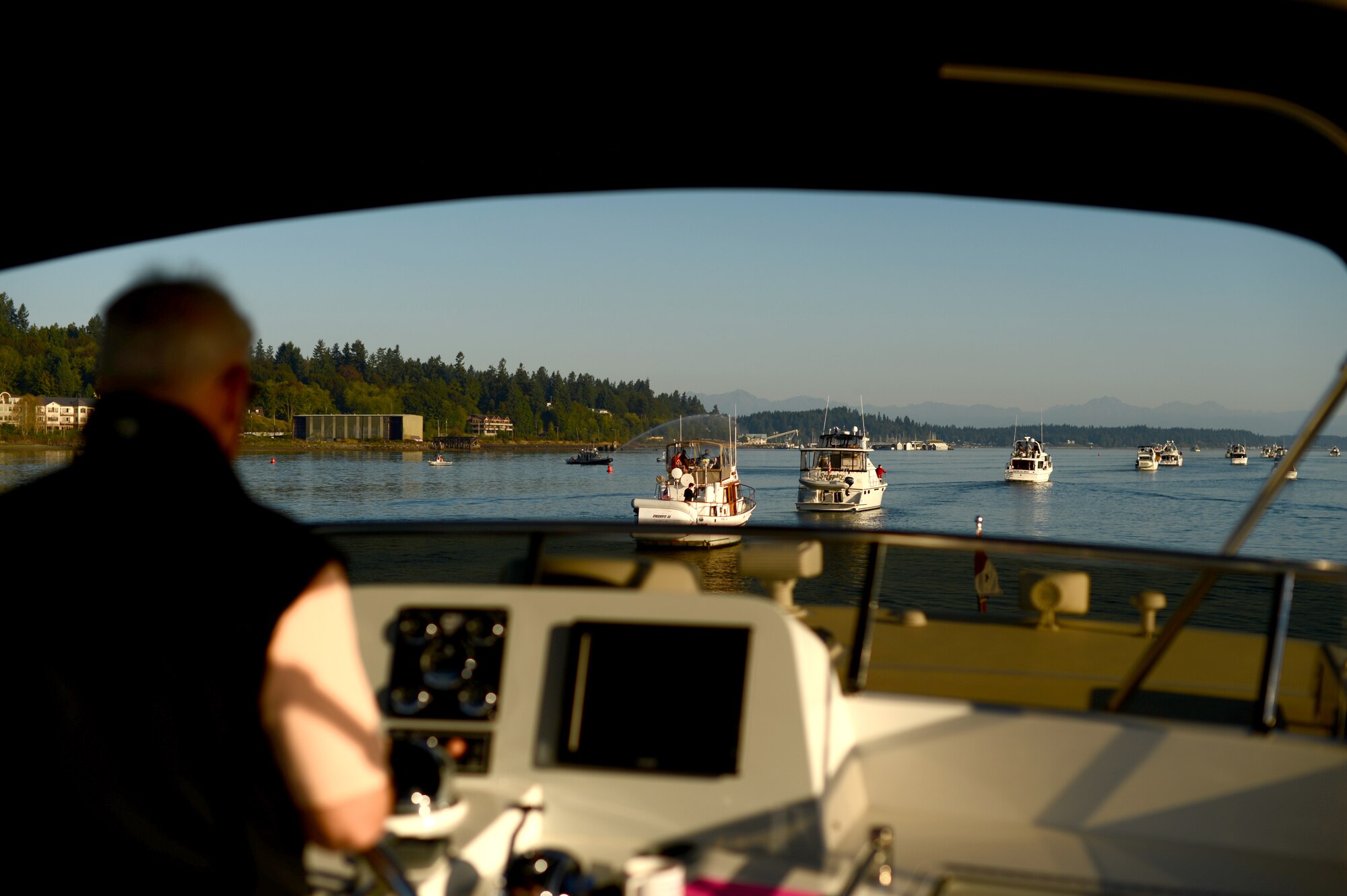 With the assistance of the Olympia Yacht Club, service members and members of the Thurston County Chamber of Commerce ride on boats to the Olympia Yacht Club Island Home Sept. 11, 2015, during Foofaraw in the Puget Sound, Wash. Foofaraw is an annual event hosted by the Olympia Yacht Club and the Thurston County Chamber of Commerce to give appreciation to service members from throughout the Puget Sound. (U.S. Air Force photo/Staff Sgt. Tim Chacon)